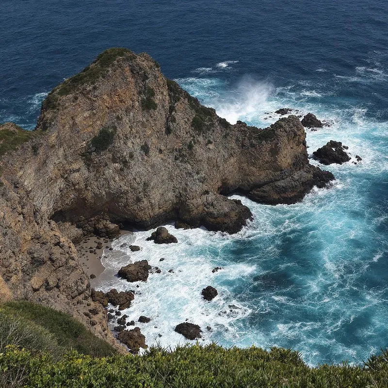 A coastal cliffside with dynamic waves