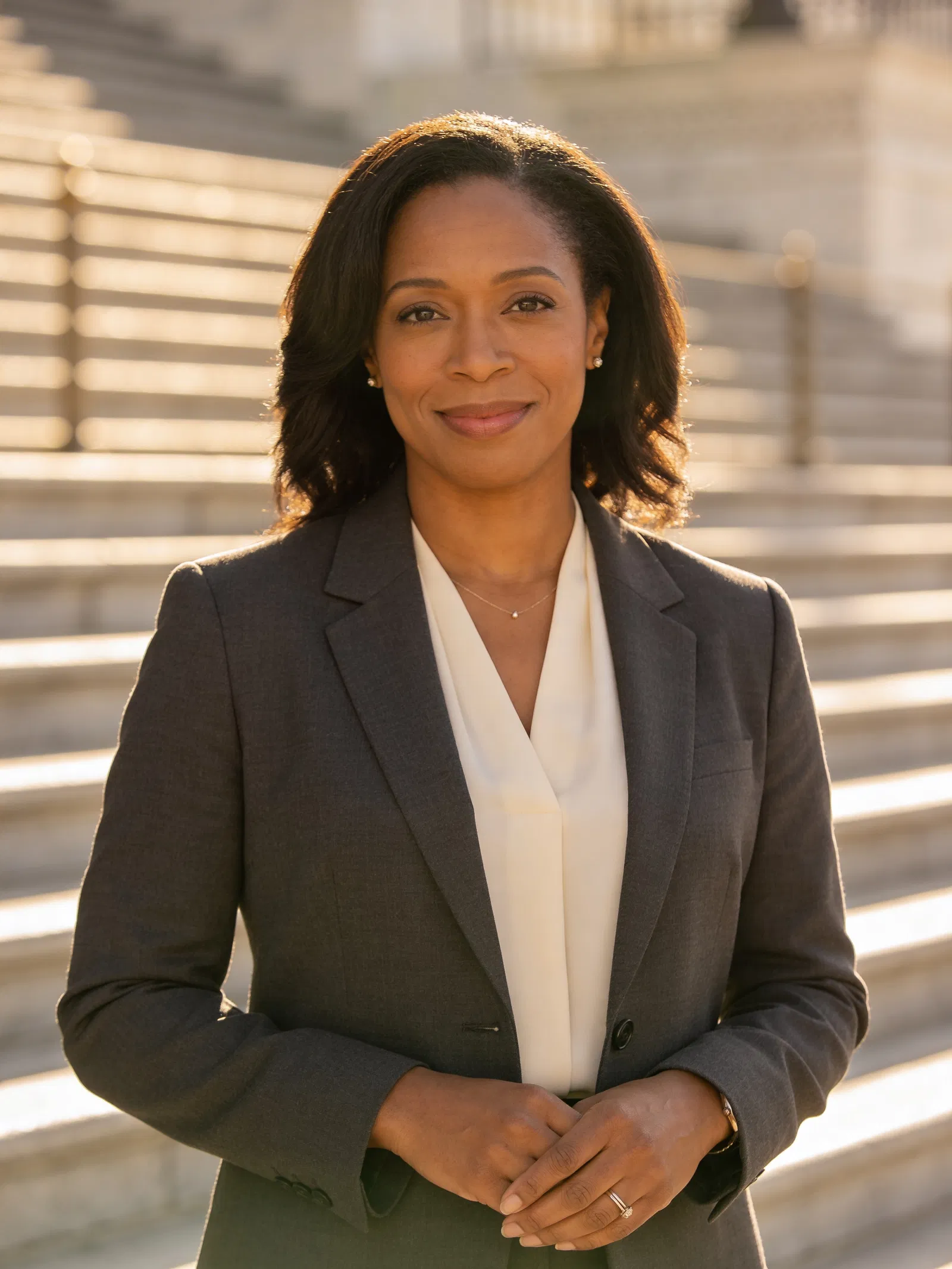 Black female lawyer half-body portrait outdoors near courthouse steps