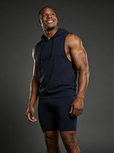 Black male bodybuilder 3/4 body portrait on seamless backdrop, dramatic studio lighting