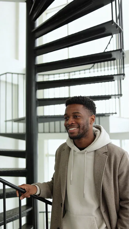 Black man in modern stairwell portrait for Instagram photoshoot vibe