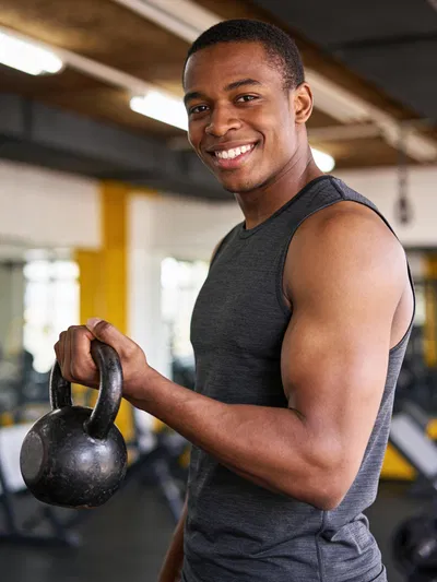Black man kettlebell portrait for fitness photoshoot