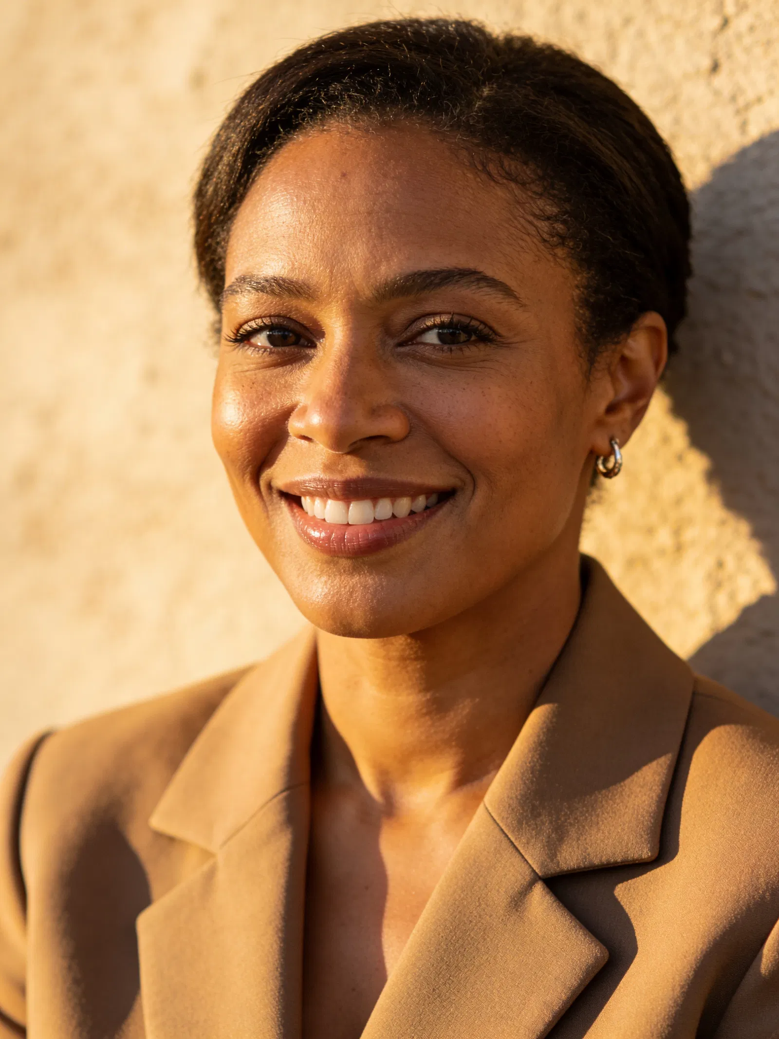 Black woman consultant headshot with confident smile for personal brand photos