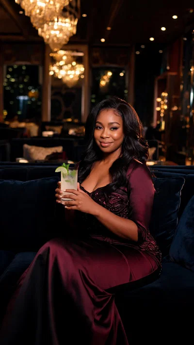 Black woman seated in luxury Dubai lounge with warm cinematic lighting