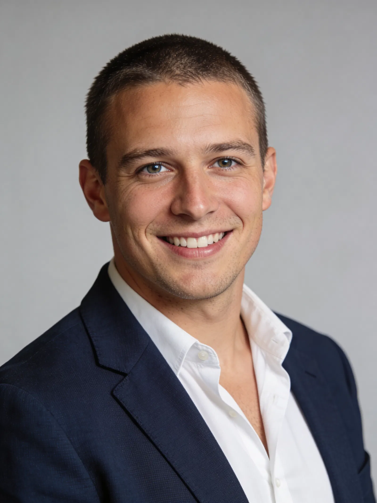 Caucasian man in blazer smiling for professional LinkedIn headshot