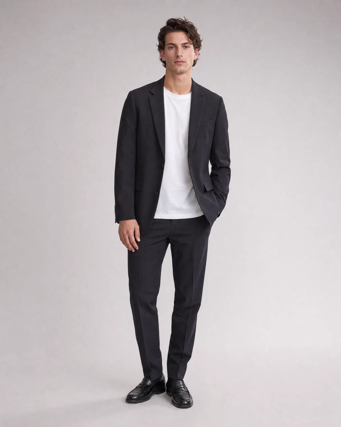Centered full-body lookbook shot on light gray seamless with even editorial lighting.