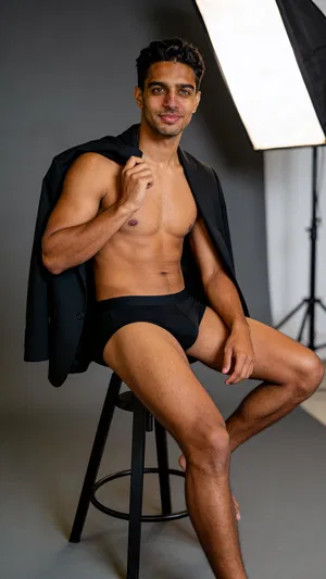 Consistent character in studio dudeoir portrait with blazer drape and soft lighting