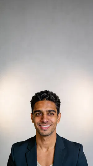 Consistent character studio headshot with blazer and soft gray background