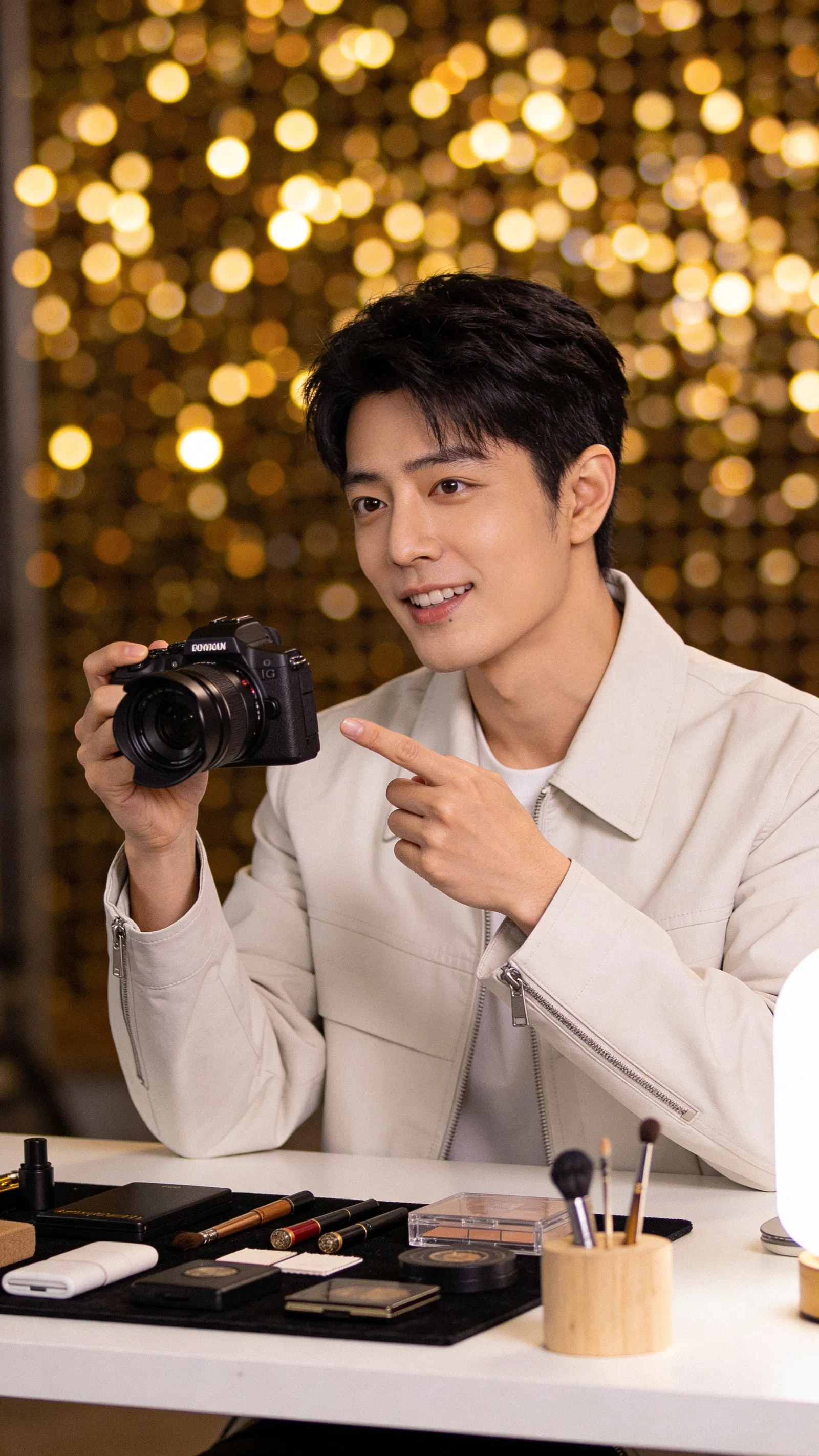 East Asian man explaining photo lighting setup for Instagram content at a desk