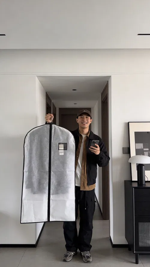 East Asian man fit-check style portrait in apartment hallway, modern social content photo