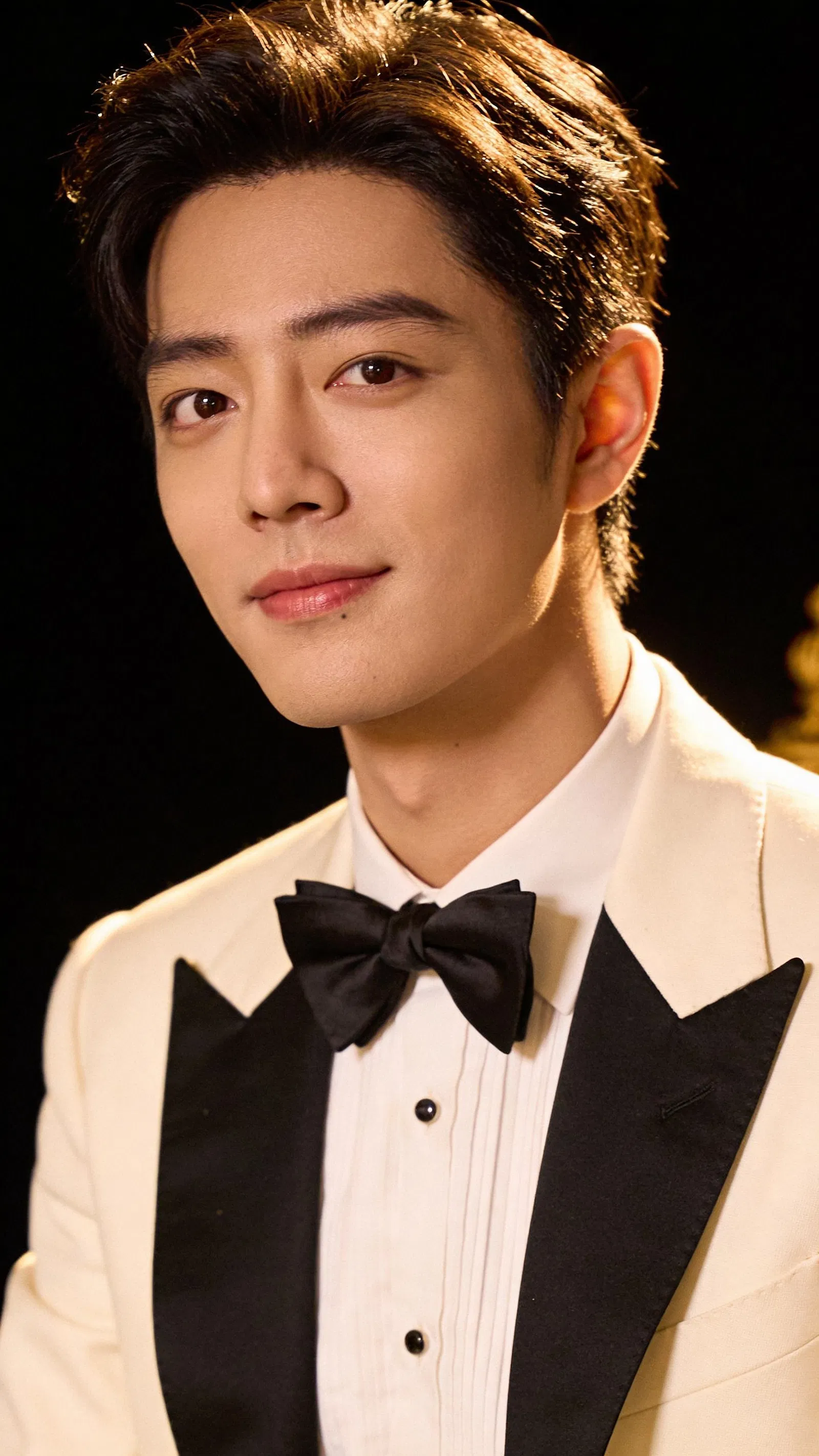 East Asian man tuxedo headshot with vintage high-contrast old Hollywood-style lighting
