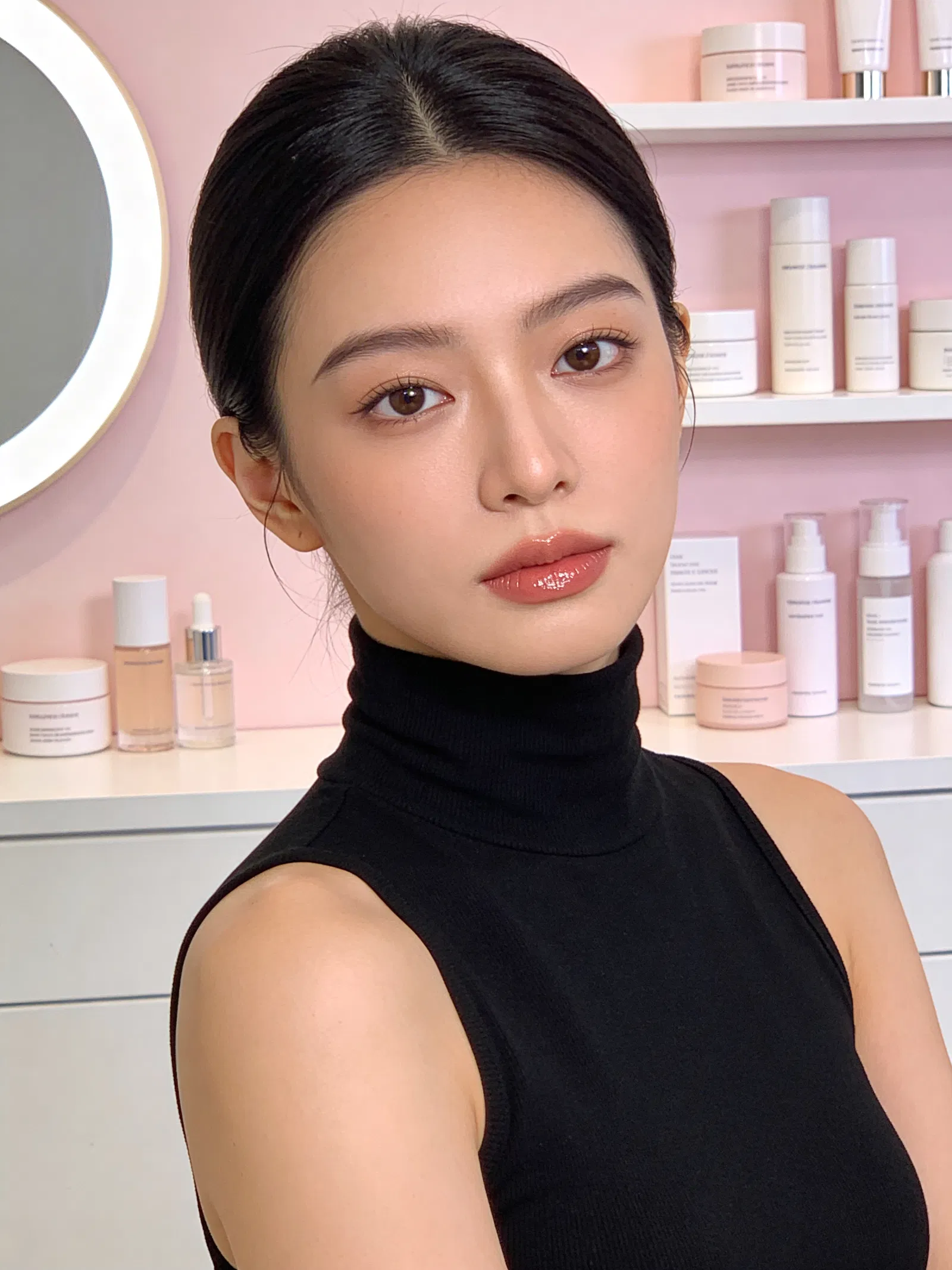 East Asian woman beauty creator headshot with studio ring-light glow