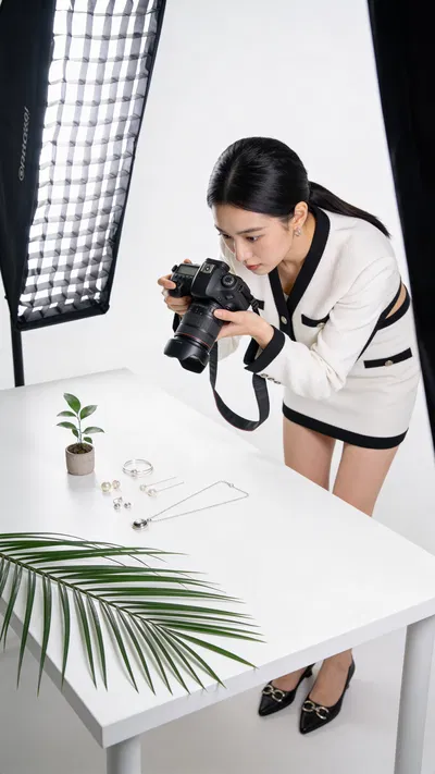 East Asian woman shooting a flat lay for an Instagram carousel