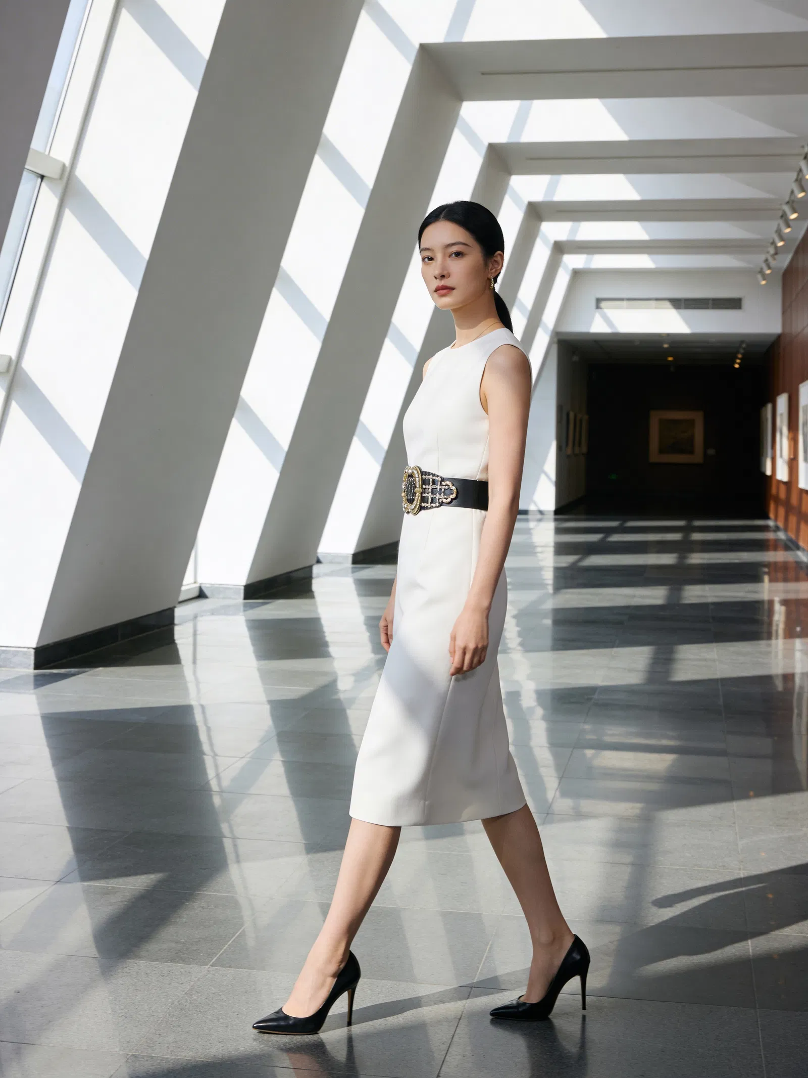 East Asian woman walking in museum hallway editorial fashion photo