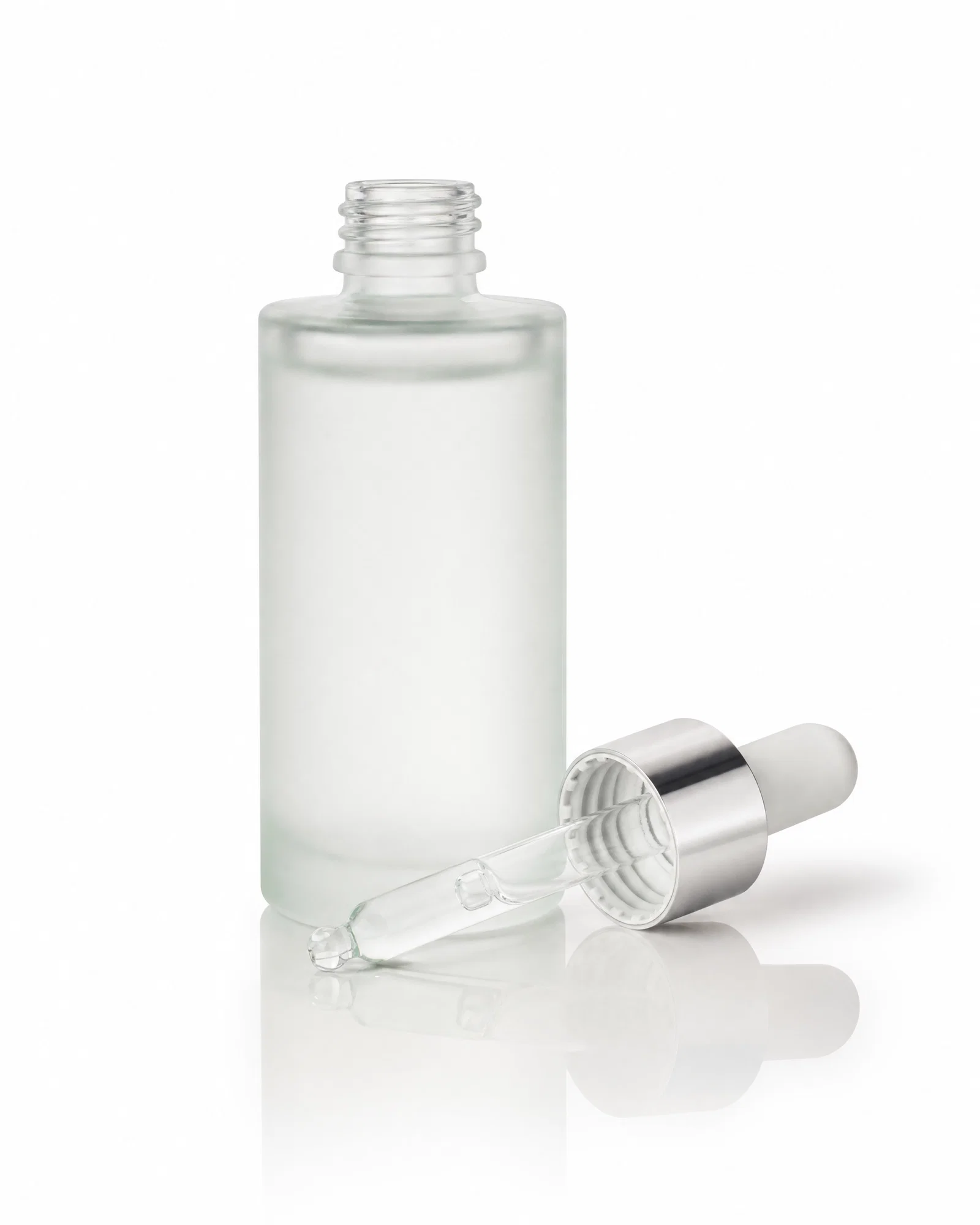Frosted serum dropper bottle on white seamless with soft shadows and clean catalog lighting.