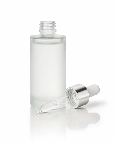 Frosted serum dropper bottle on white seamless with soft shadows and clean catalog lighting.