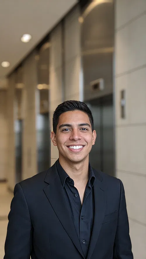 Hispanic man in elevator lobby with polished professional resume portrait