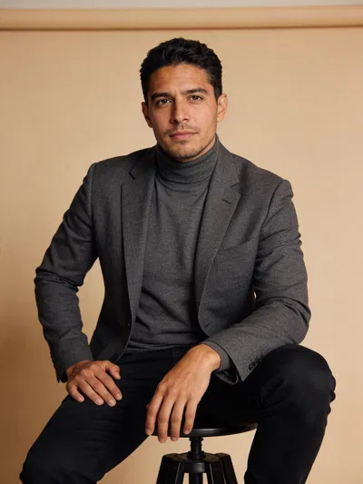 Hispanic man seated studio portrait for personal branding photography