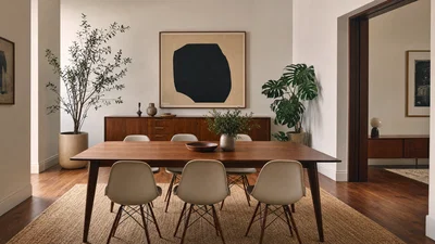 Mid-century dining room shot wide with walnut table, soft daylight, and balanced HDR.