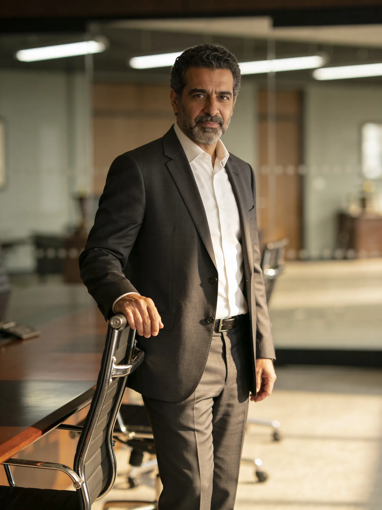 Middle Eastern male lawyer three-quarter portrait in law firm conference room