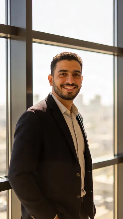 Middle Eastern man by window with professional CV portrait lighting