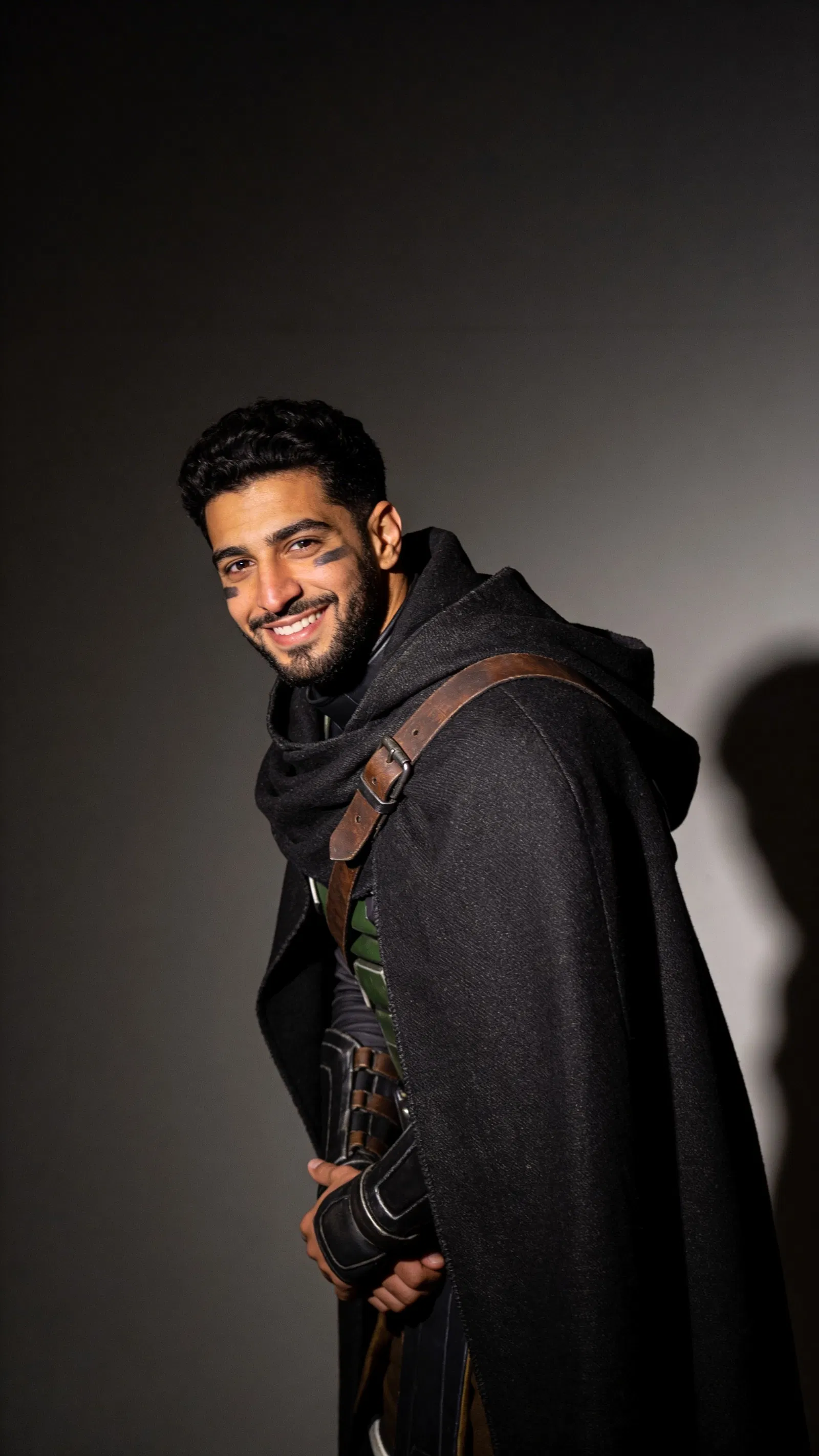 Middle Eastern man in rogue cosplay, dramatic half-body studio portrait