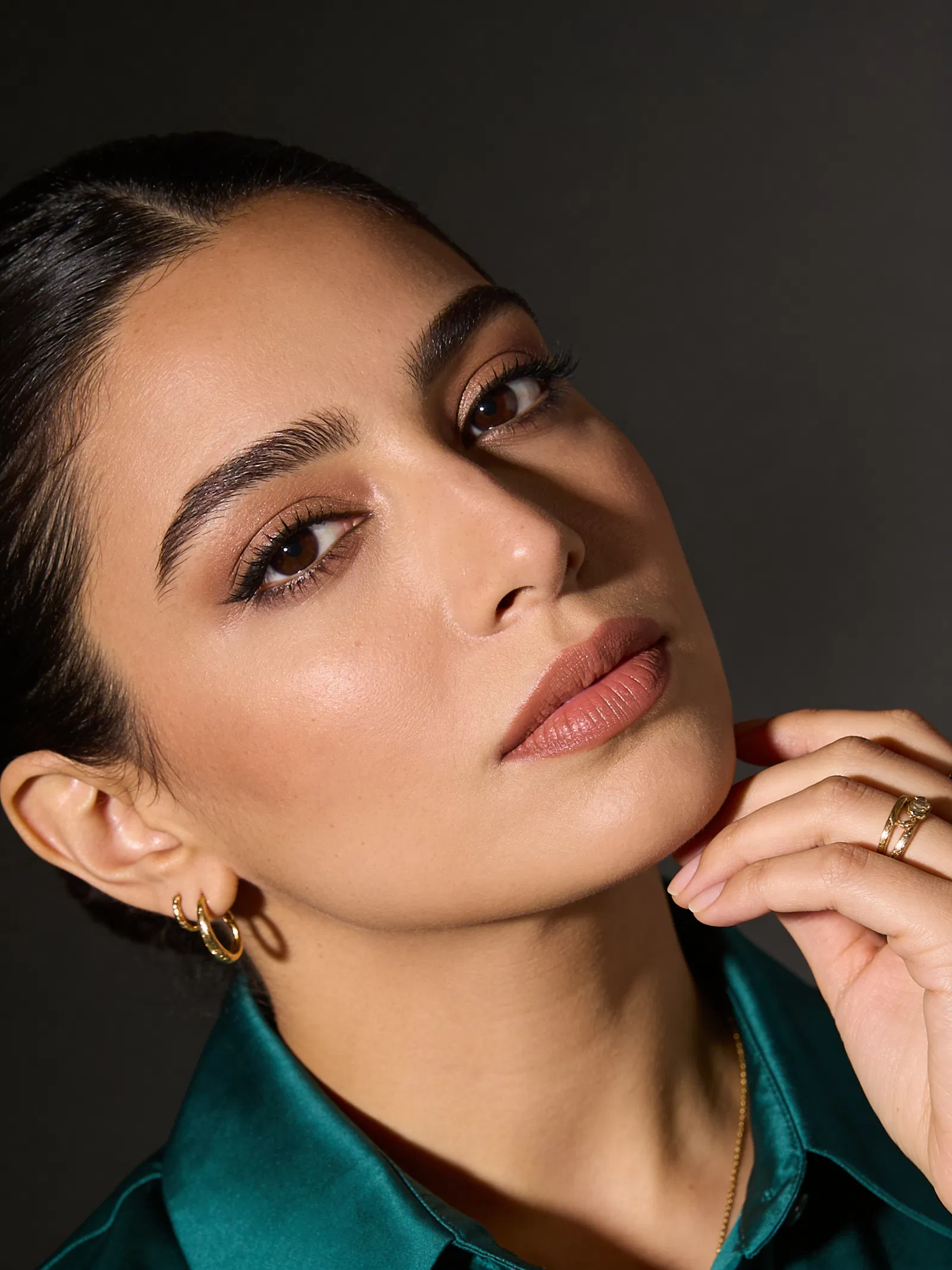 Middle Eastern woman studio beauty headshot with soft dramatic lighting
