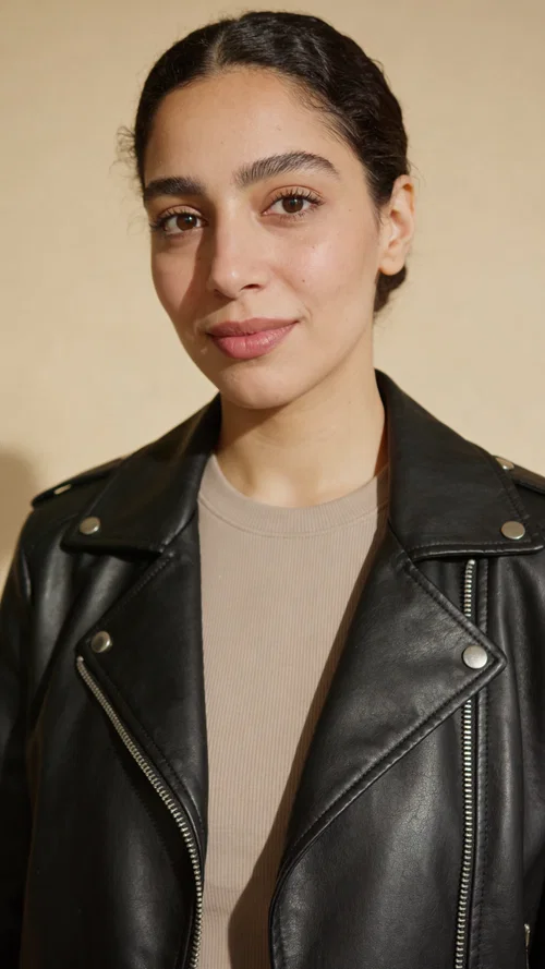Middle Eastern woman studio portrait in leather jacket, premium creator branding photo