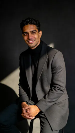 Moody studio seated portrait with sculpted editorial glamour lighting