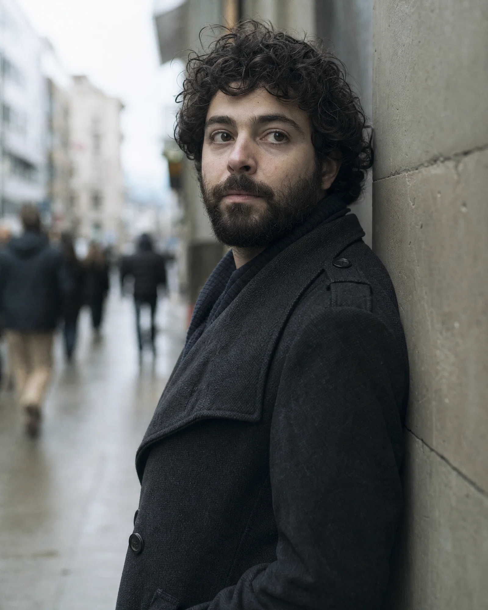 Overcast street portrait with muted tones, sharp eyes, and soft background blur.