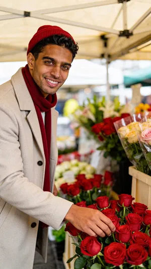 Same character at flower market choosing roses, bright candid lifestyle look.