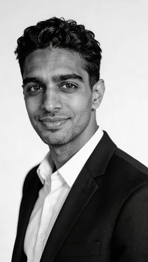 Same character in black-and-white corporate headshot style