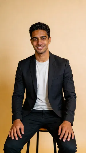 Same character in warm studio, half-body professional AI headshot