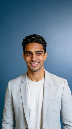 Same character on blue studio backdrop for brand-consistent corporate headshot