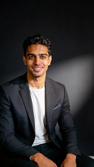 Same character premium executive studio portrait with dark charcoal background