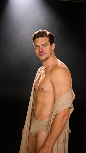 Same character side chest pose in dark studio, 3/4 body framing