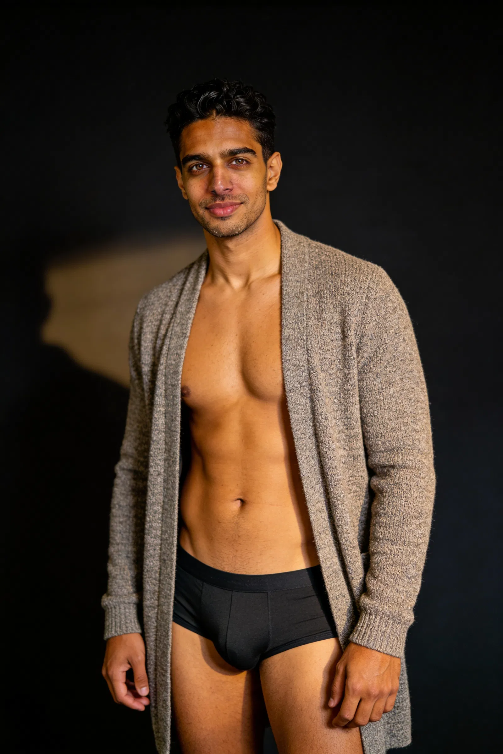 Same man in moody studio male boudoir portrait with rim light