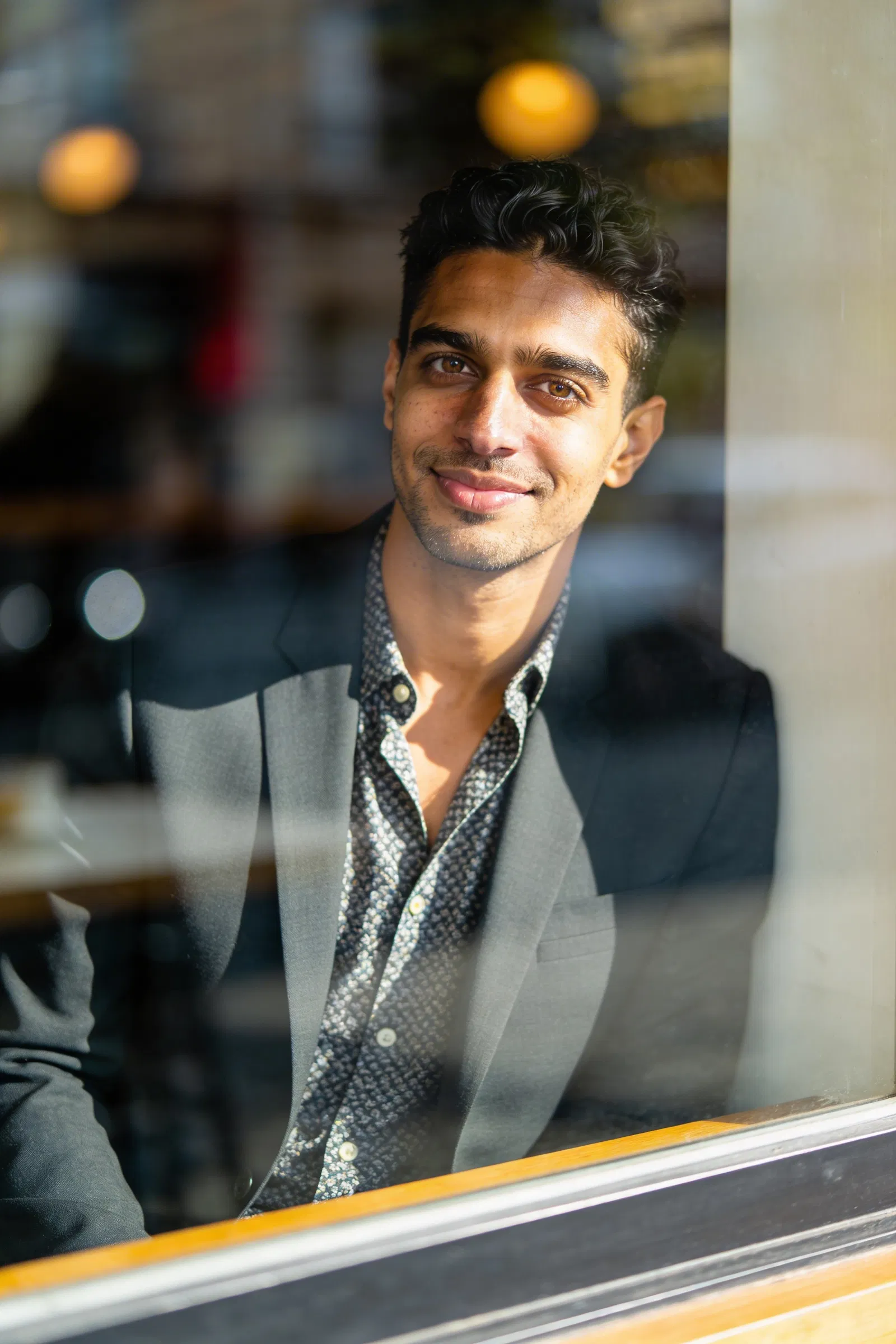 Same person café window editorial portrait