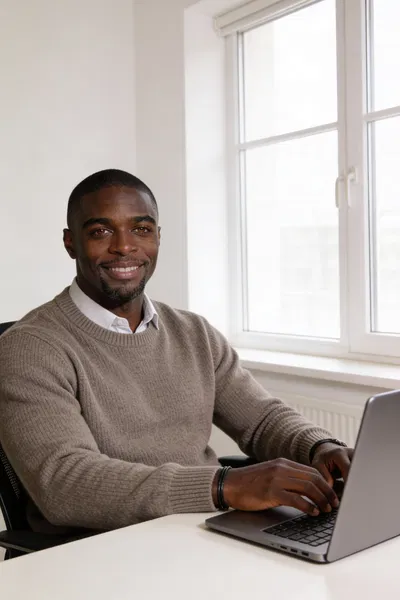 Same person seated at home office desk for personal brand photo