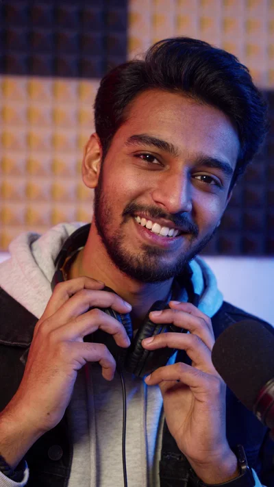 South Asian man in music studio, creative promo portrait for social media