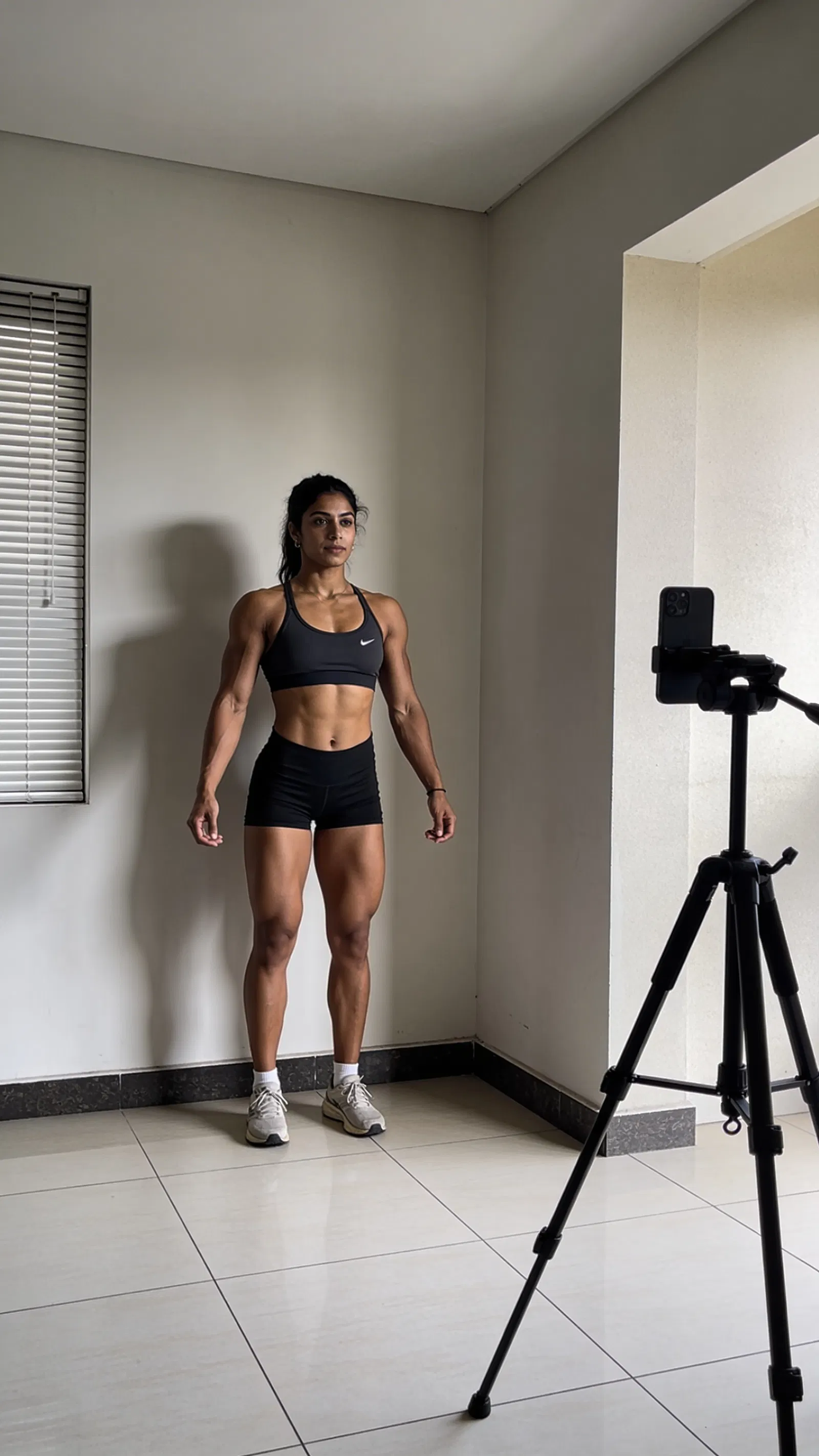 South Asian woman bodybuilder home-gym progress photo setup with consistent framing