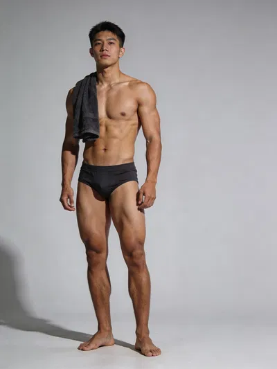 Southeast Asian male bodybuilder full-body studio portrait showing balanced physique