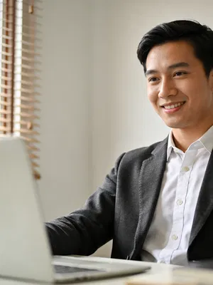 Southeast Asian man in blazer in home office, professional headshot