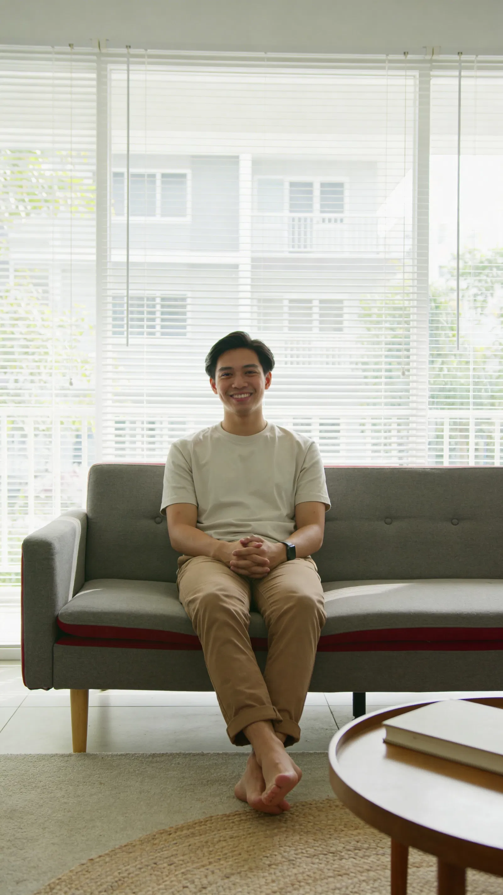 Southeast Asian man on sofa for instant Instagram photos from home