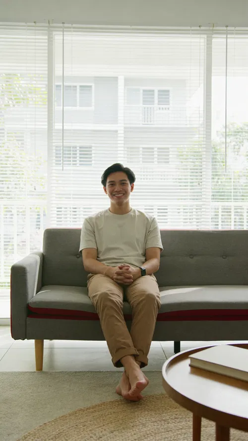 Southeast Asian man on sofa for instant Instagram photos from home