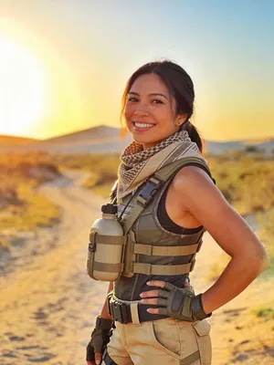 Southeast Asian woman in desert ranger Fortnite-inspired cosplay at sunset outdoors