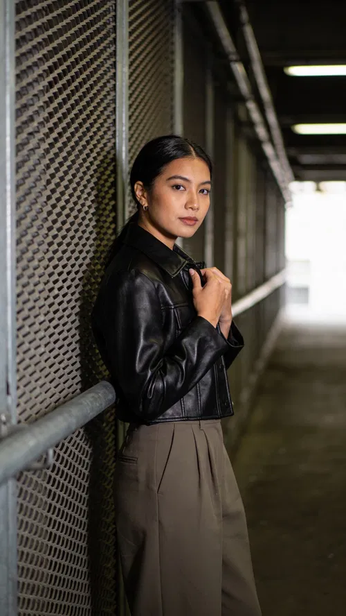 Southeast Asian woman in moody corridor editorial fashion portrait