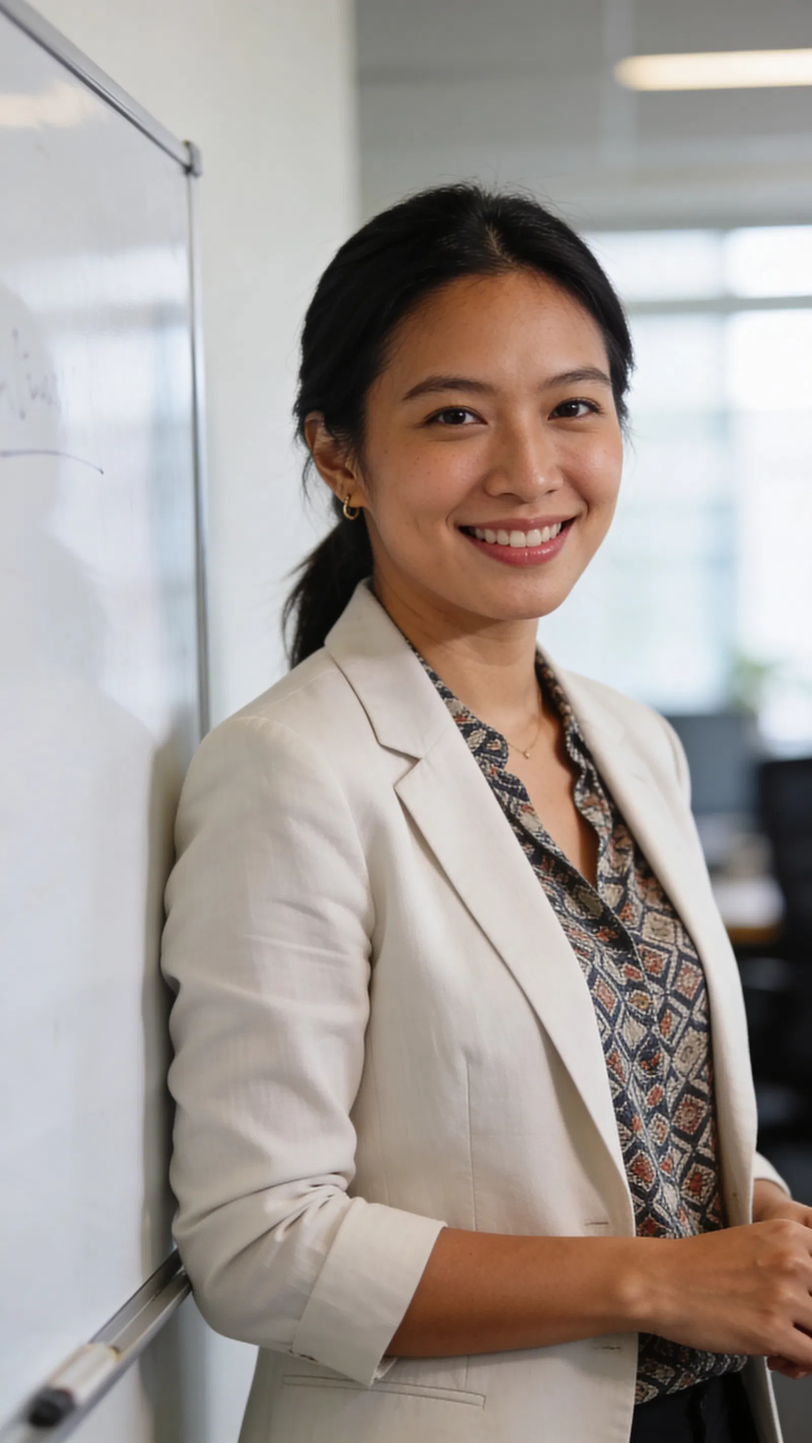 Southeast Asian woman in office, clean 3/4 professional portrait style