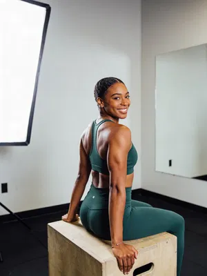 Toned woman seated in boutique gym for professional fitness photos