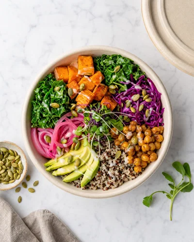 Top-down grain bowl in takeout container on marble, even soft side light, neutral grade.
