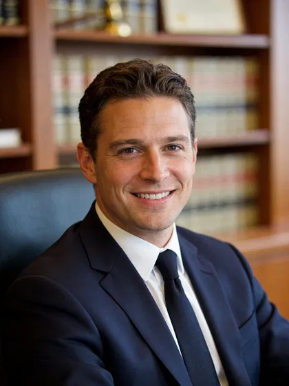 White male attorney headshot in law office, confident and approachable